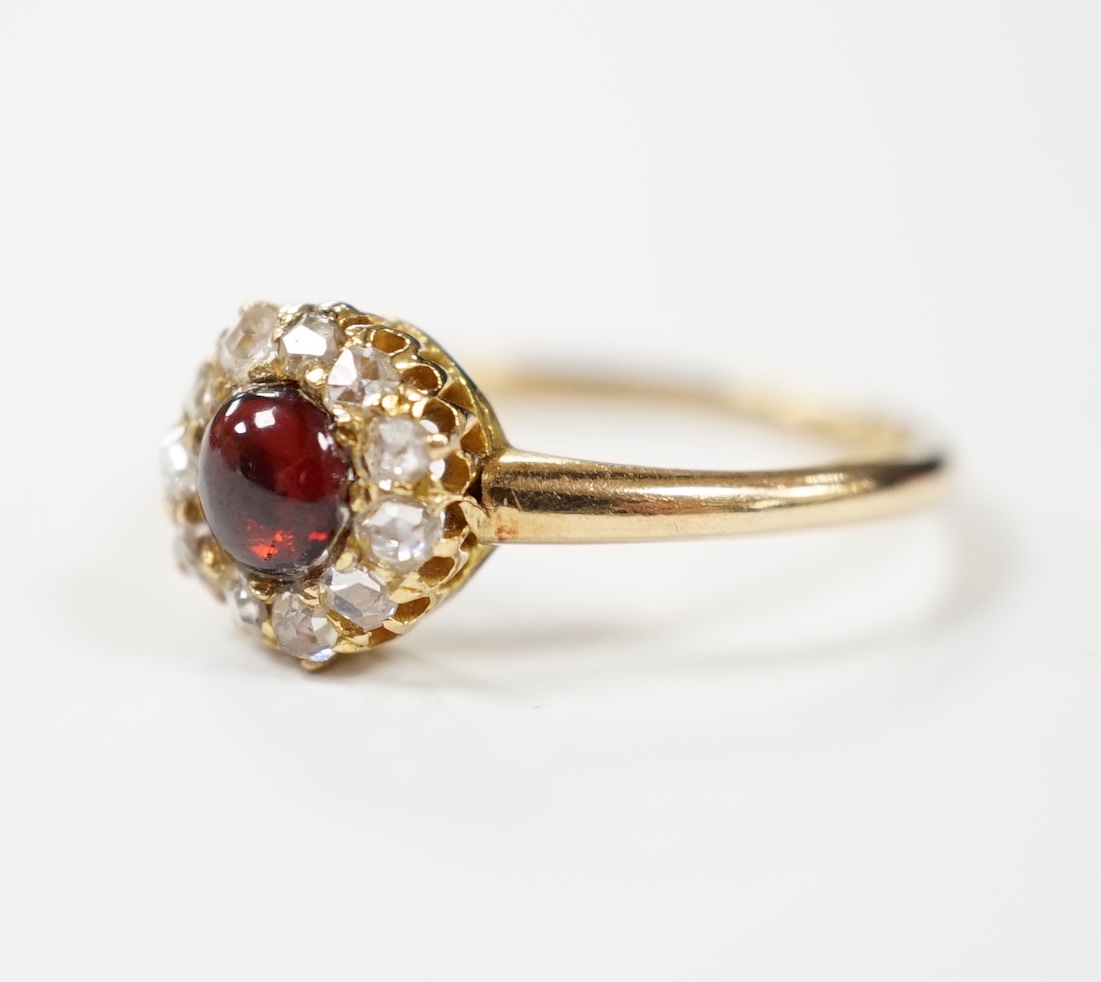 An 18ct, foil backed cabochon and diamond cluster set dress ring, by Annina Vogel, size M/N, gross weight 2.7 grams.